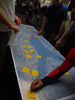 Community members post notes on a map of the project area. Photo by the author.