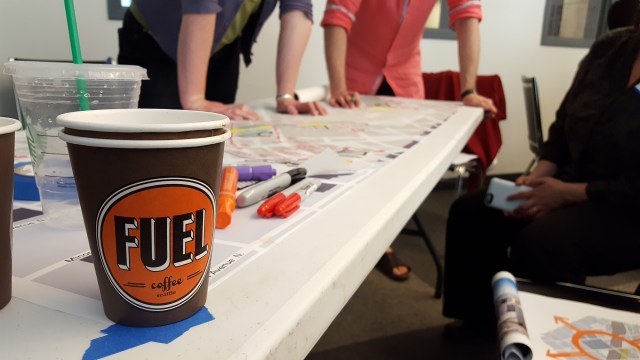 A Lid I-5 charrette team gathers around their drawings. (Photo by the author)